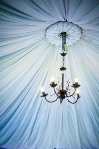 Low angle view of illuminated chandelier in gazebo