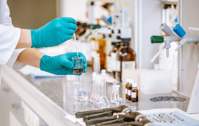 Cropped hands of scientist experimenting at laboratory