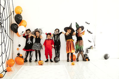Group of people with balloons against white background