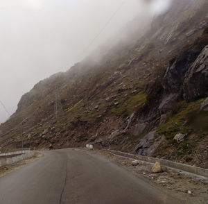 Road amidst mountains against sky