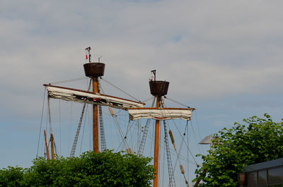 Low angle view of lookout towers on sailing ship mast against sky