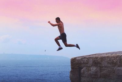 Full length of woman jumping in mid-air