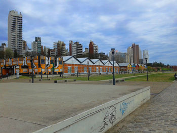 Empty road against buildings in city