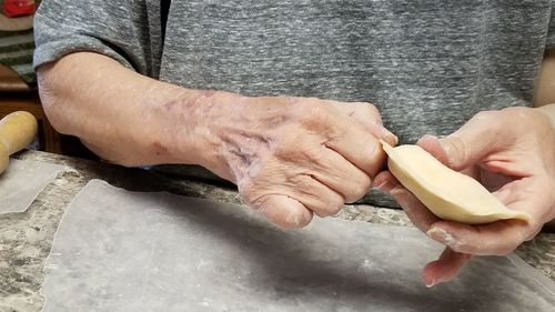 Cropped image of person preparing food on table