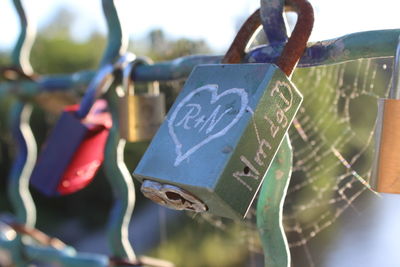 Close-up of padlocks hanging on heart shape