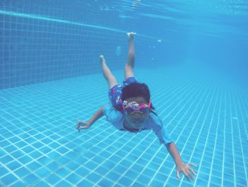 High angle view of boy swimming in pool