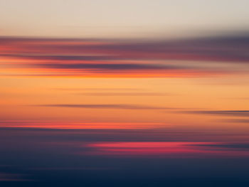 Scenic view of sea against romantic sky at sunset