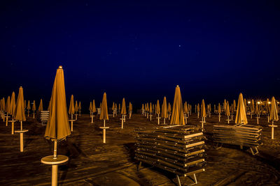 Panoramic view of illuminated built structure against blue sky at night