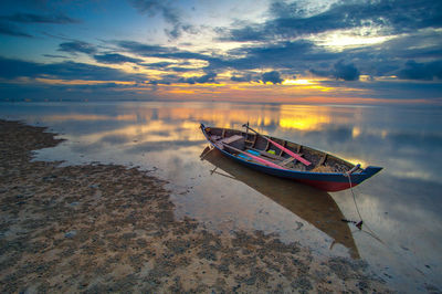 View of boat in sea at sunset
