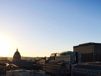 View of cityscape against clear blue sky