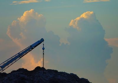 Low angle view of crane against sky during sunset