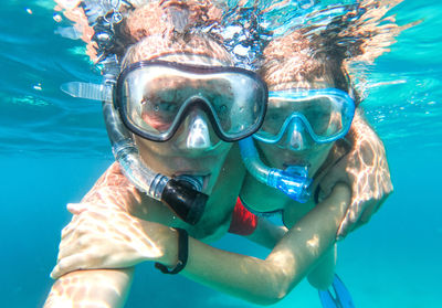 Portrait of couple snorkeling in sea