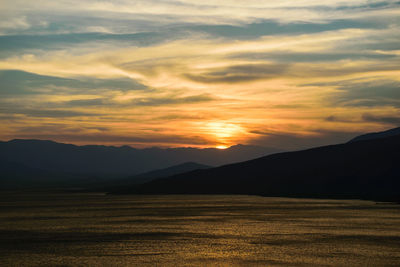 Scenic view of manjeel dam lake at sunset
