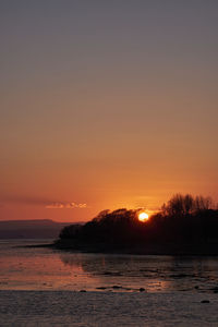 Scenic view of sea against romantic sky at sunset