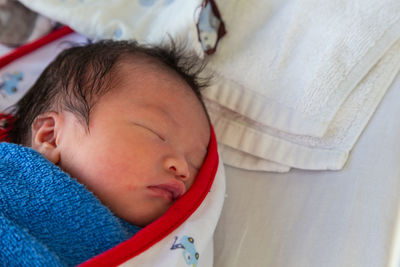 Close-up cute baby sleeping on bed