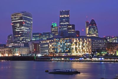 River with illuminated buildings in distance