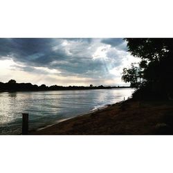 Scenic view of lake against cloudy sky