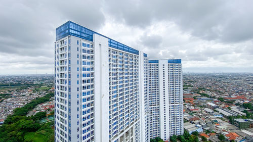 Modern buildings in city against sky