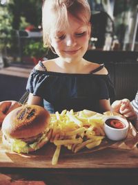 Midsection of girl having food in plate