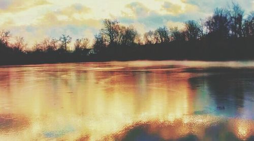 Scenic view of lake at sunset