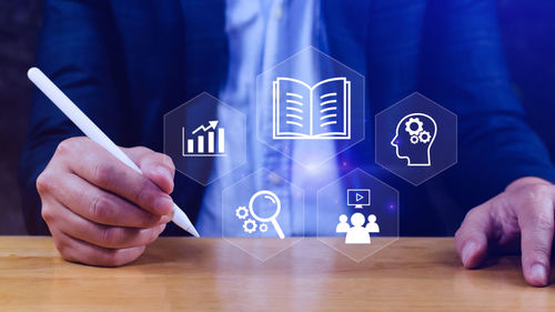 Midsection of businessman holding text on table