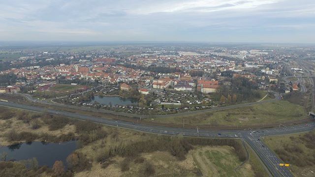 cityscape, high angle view, built structure, architecture, city, sky, aerial view, building exterior, cloud - sky, transportation, landscape, road, crowded, cloud, tree, residential district, river, cloudy, horizon over land, connection