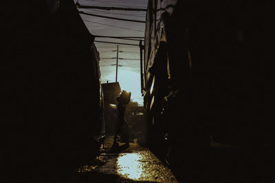 Silhouette people walking on street in city