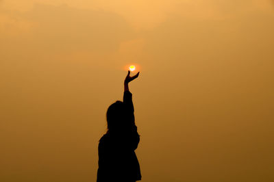 Silhouette of people at sunset