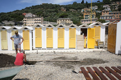 Low angle view of yellow construction site by buildings in city