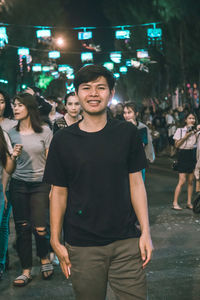 Group of people enjoying music concert at night