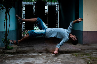 Full length of man relaxing on floor