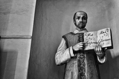 Portrait of man standing against wall