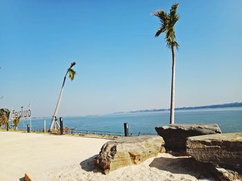 Scenic view of beach against clear blue sky