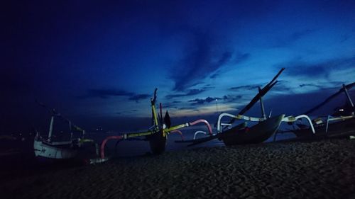 Boats in sea against cloudy sky