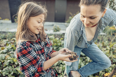 Smiling friends using mobile phone