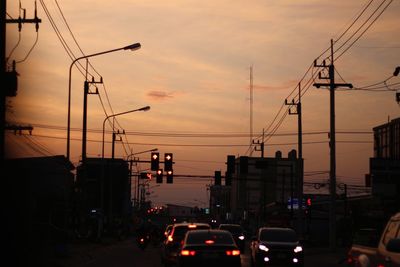 Traffic on road at sunset