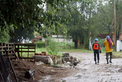 Woman standing on tree trunk