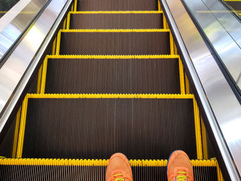 Low section of person on escalator