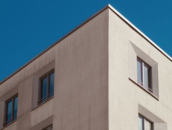 Low angle view of building against clear blue sky