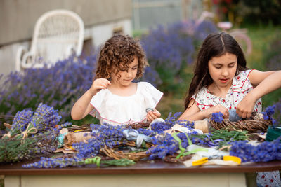 Portrait of smiling young woman picking flowers