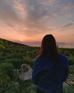 Rear view of woman looking at sunset