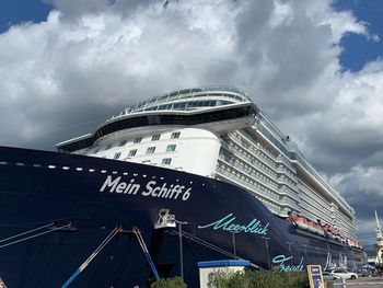 Low angle view of modern building against cloudy sky