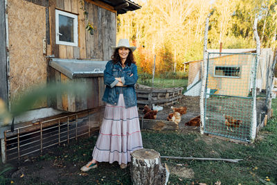 Full length of young woman standing in abandoned house