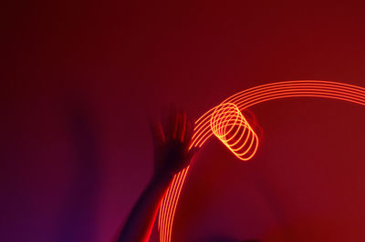 Close-up of light painting against red background