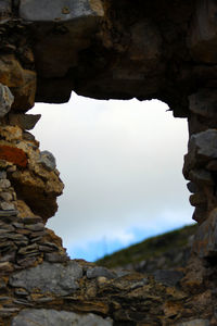 Low angle view of rock formation against sky