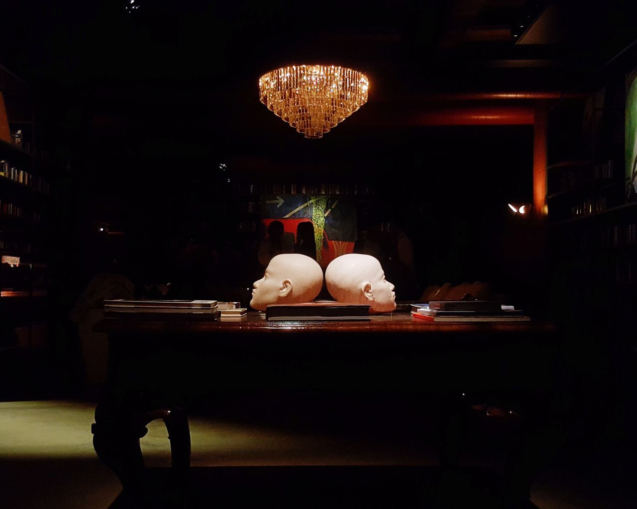 PEOPLE SITTING IN RESTAURANT BY ILLUMINATED TABLE