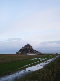 Church by building against sky