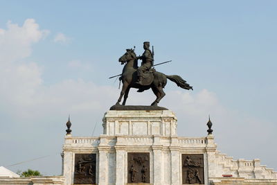 Low angle view of statue against sky