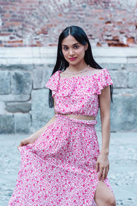 Portrait of young woman standing at beach