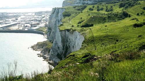 Scenic view of sea and mountains against sky